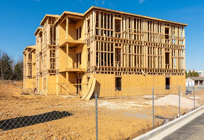 a job site enclosed by temporary chain link fences, ensuring safety for workers and pedestrians in Irving TX